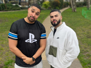 Marcus and Kae Kurd standing in a park looking charming